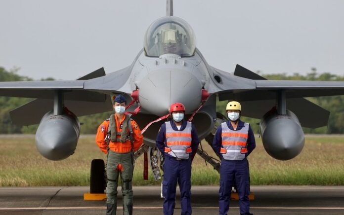 Pilot dan perwira angkatan laut berpose di depan pesawat tempur F-16V di komisi skuadron pertama pesawat tempur F-16V yang ditingkatkan di Pangkalan Angkatan Udara Chiayi, Chiayi, Taiwan, 18 November 2021. Foto: Reuters.