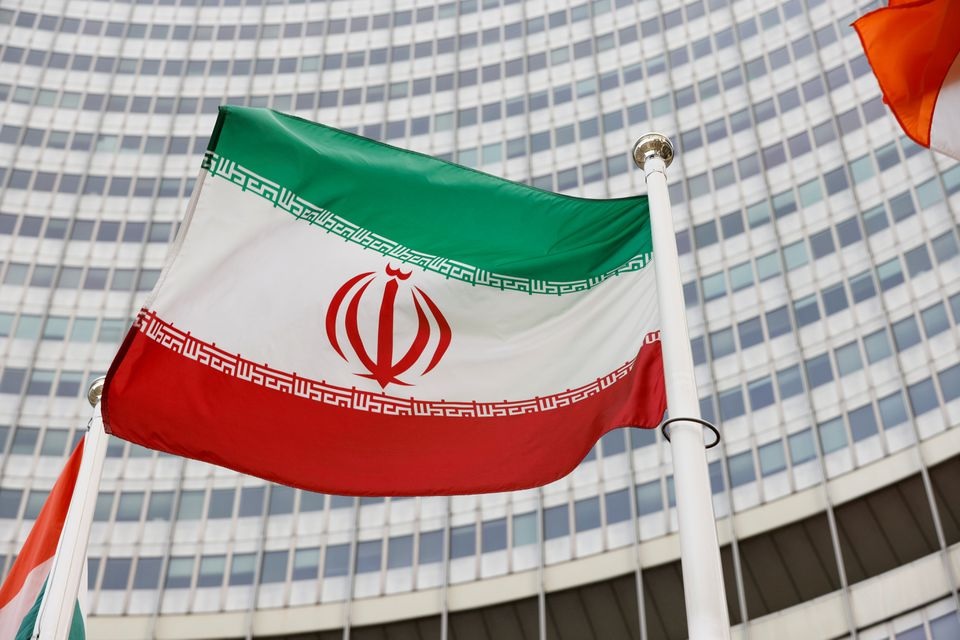 Bendera Iran melambai di depan markas Badan Energi Atom Internasional (IAEA), di tengah pandemi COVID-19, di Wina, Austria, 23 Mei 2021. Foto: Reuters.