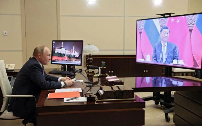 Presiden Rusia Vladimir Putin mengadakan pembicaraan dengan Presiden China Xi Jinping melalui tautan video di kediamannya di luar Moskow, Rusia, 15 Desember 2021. Foto: Sputnik.