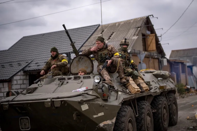 Tentara Ukraina mengendarai kendaraan militer lapis baja di pinggiran Kyiv, Ukraina, pada 5 Maret 2022. Foto: AP/Emilio Morenatti.