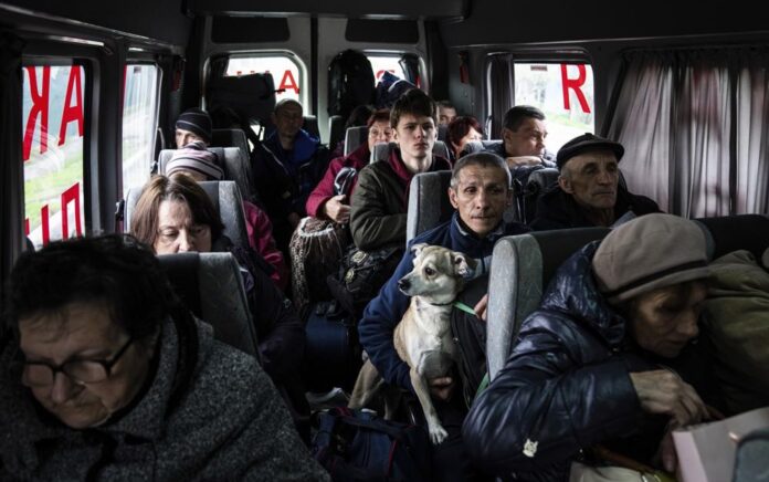 Orang-orang duduk di dalam bus saat evakuasi dari Lyman, wilayah Donetsk, Ukraina timur, Sabtu, 30 April 2022. Foto: AP Photo/Evgeniy Maloletka.