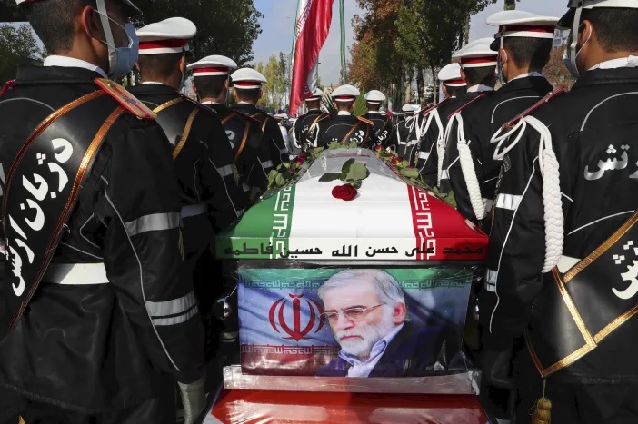 Personel militer Iran berdiri di dekat peti mati berbendera yang membahwa jenazah Mohsen Fakhrizadeh, seorang ilmuwan yang terbunuh, saat upacara pemakaman di Teheran, Iran, Senin, 30 November. 2020. Foto: Kementerian Pertahanan Iran via AP.