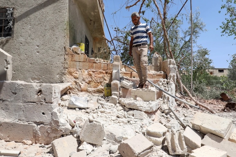 Seorang pria Suriah memeriksa sebuah rumah yang rusak setelah penembakan artileri rezim yang dilaporkan di provinsi barat laut Idlib. Foto: Abdulaziz Ketaz/AFP.