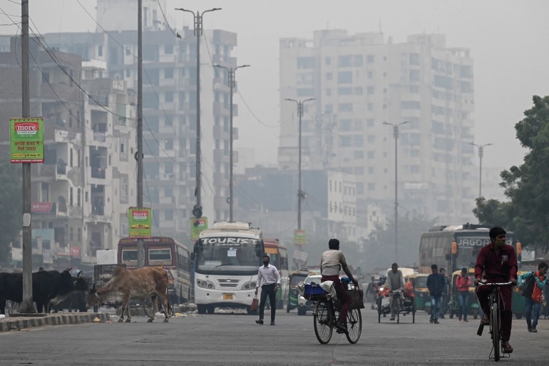 Para komuter berjalan di tengah kondisi kabut asap di New Delhi. Foto: Prakash Singh/AFP.