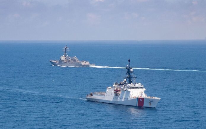 Kapal perusak berpeluru kendali kelas Arleigh Burke USS Kidd dan US Coast Guard cutter Munro melakukan transit di Selat Taiwan 27 Agustus 2021. Gambar diambil 27 Agustus 2021. Foto: US Navy/Handout via Reuters.