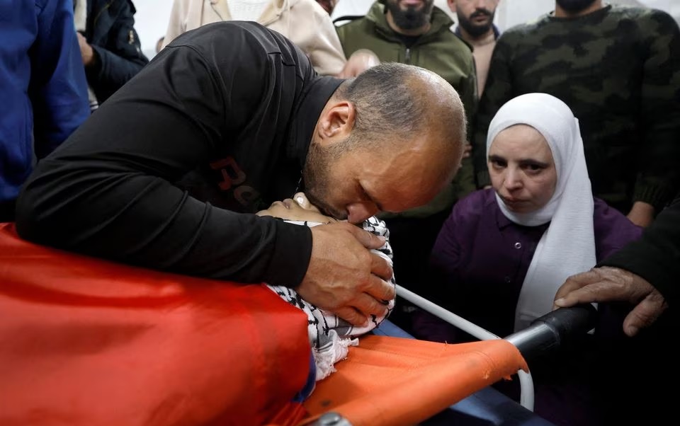Para pelayat bereaksi di samping jenazah Mustafa Sabbah yang berusia 16 tahun, yang tewas dalam bentrokan dengan pasukan Israel, di sebuah rumah sakit di Bethlehem di Tepi Barat yang diduduki Israel pada 28 April 2023. Foto: Reuters/ Mussa Qawasma.