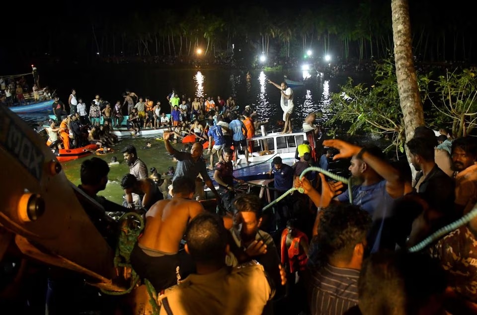 Anggota tim penyelamat mencari korban setelah sebuah perahu terbalik di lepas pantai kota Tanur di distrik Malappuram di selatan negara bagian Kerala, India, 7 Mei 2023. Foto: Reuters/Stringer.