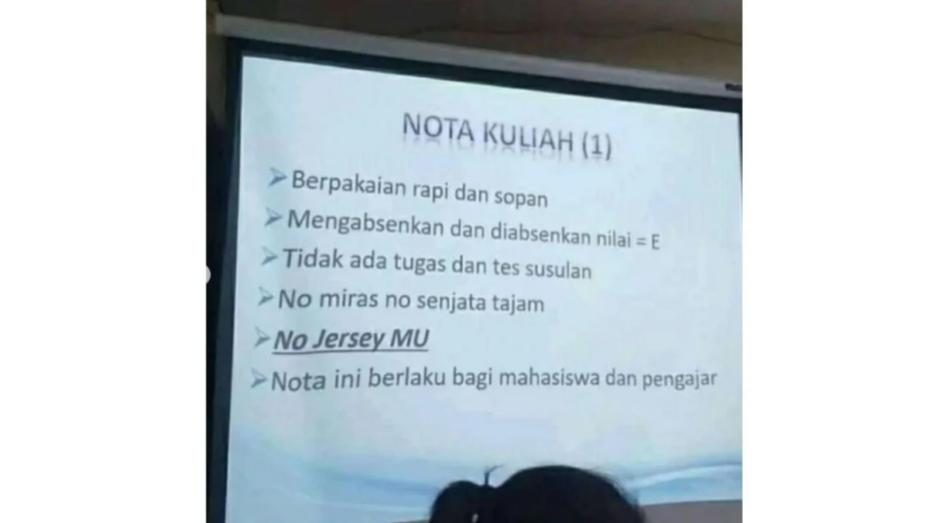 Salah satu poin larangan di kampus yang berbunyi, "No jersey MU," yang ditulis dengan cetakan tebal, miring, dan diberi garis bawah, menandakan pentingnya larangan tersebut.